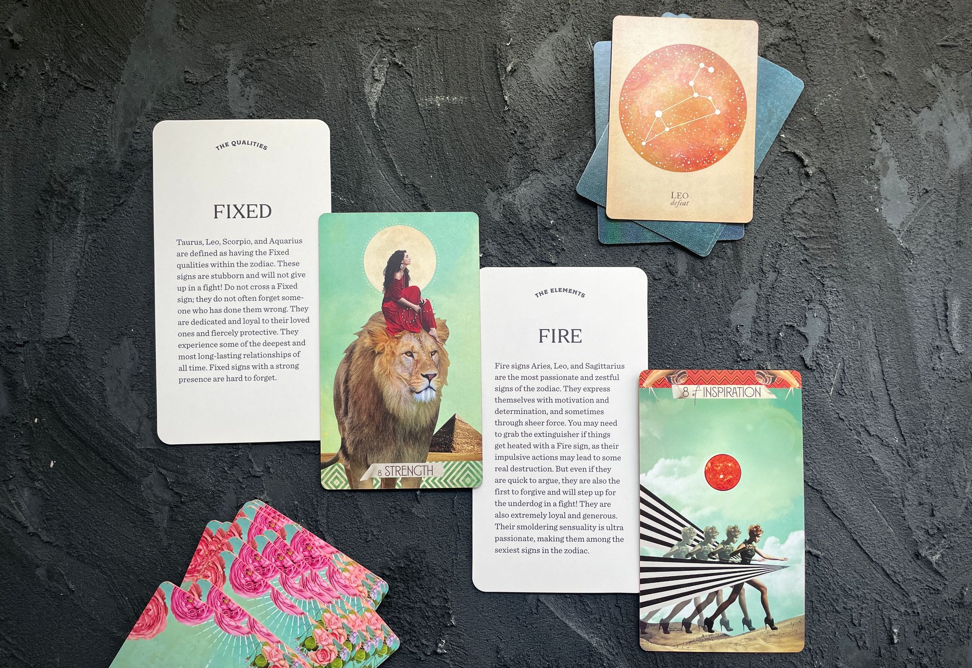 fixed and fire cards from the astrology deck, strength and the 8 of inspiration (wands) from the muse tarot, leo from the compendium of constellations