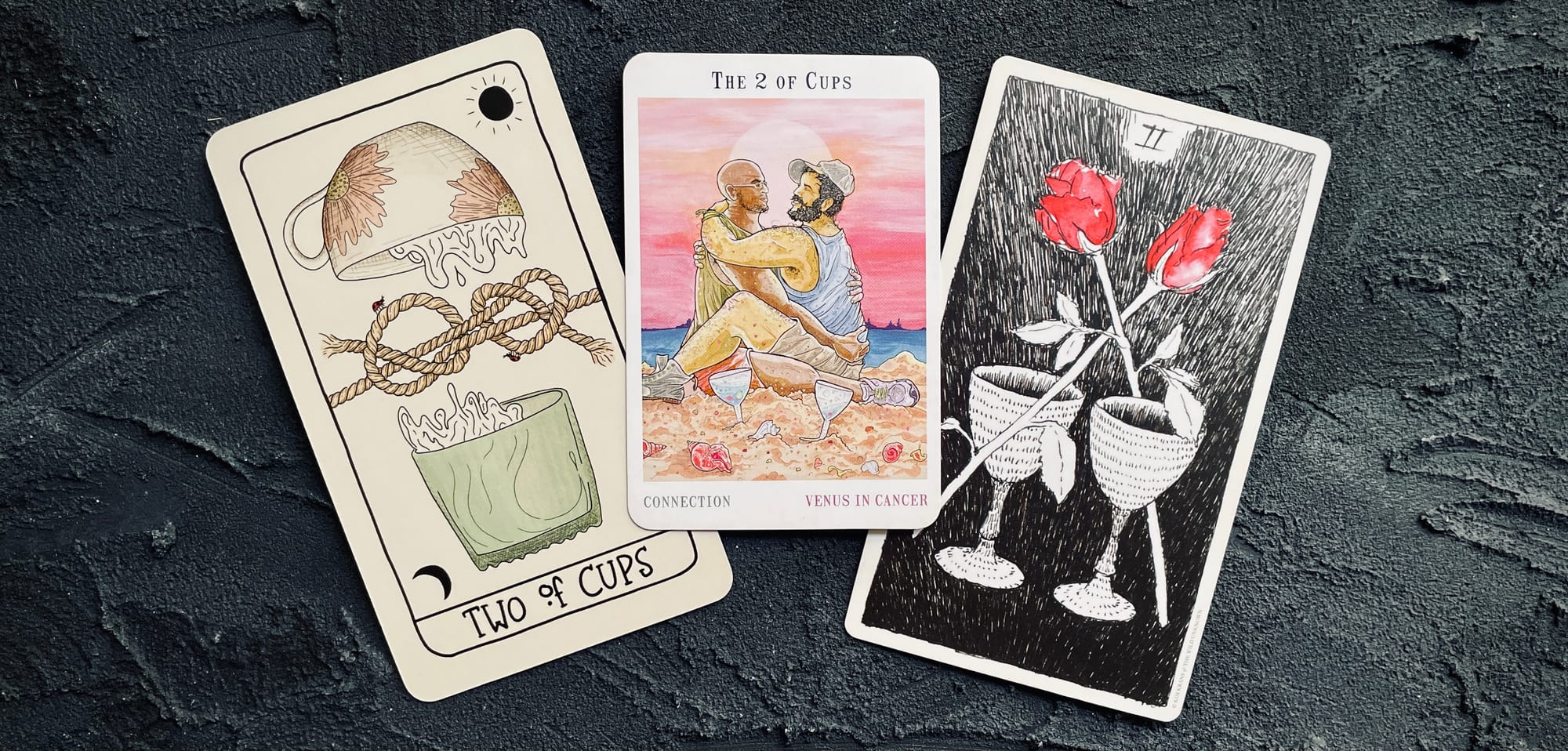 two of cups from the fifth spirit tarot (left), next world tarot (center), and wild unknown tarot (right)