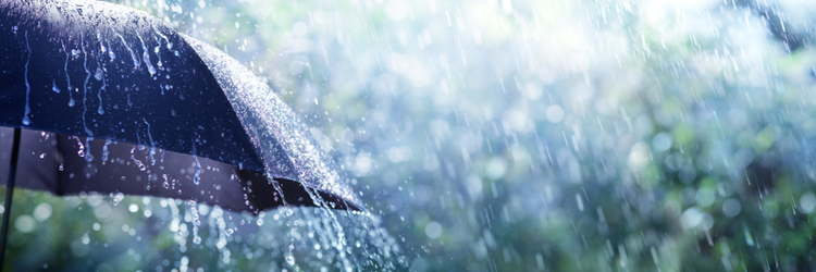 umbrella with rain pouring down on it